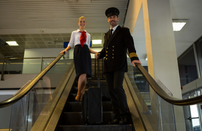 Commercial pilot in uniform standing near an airplane – highest paying job in India